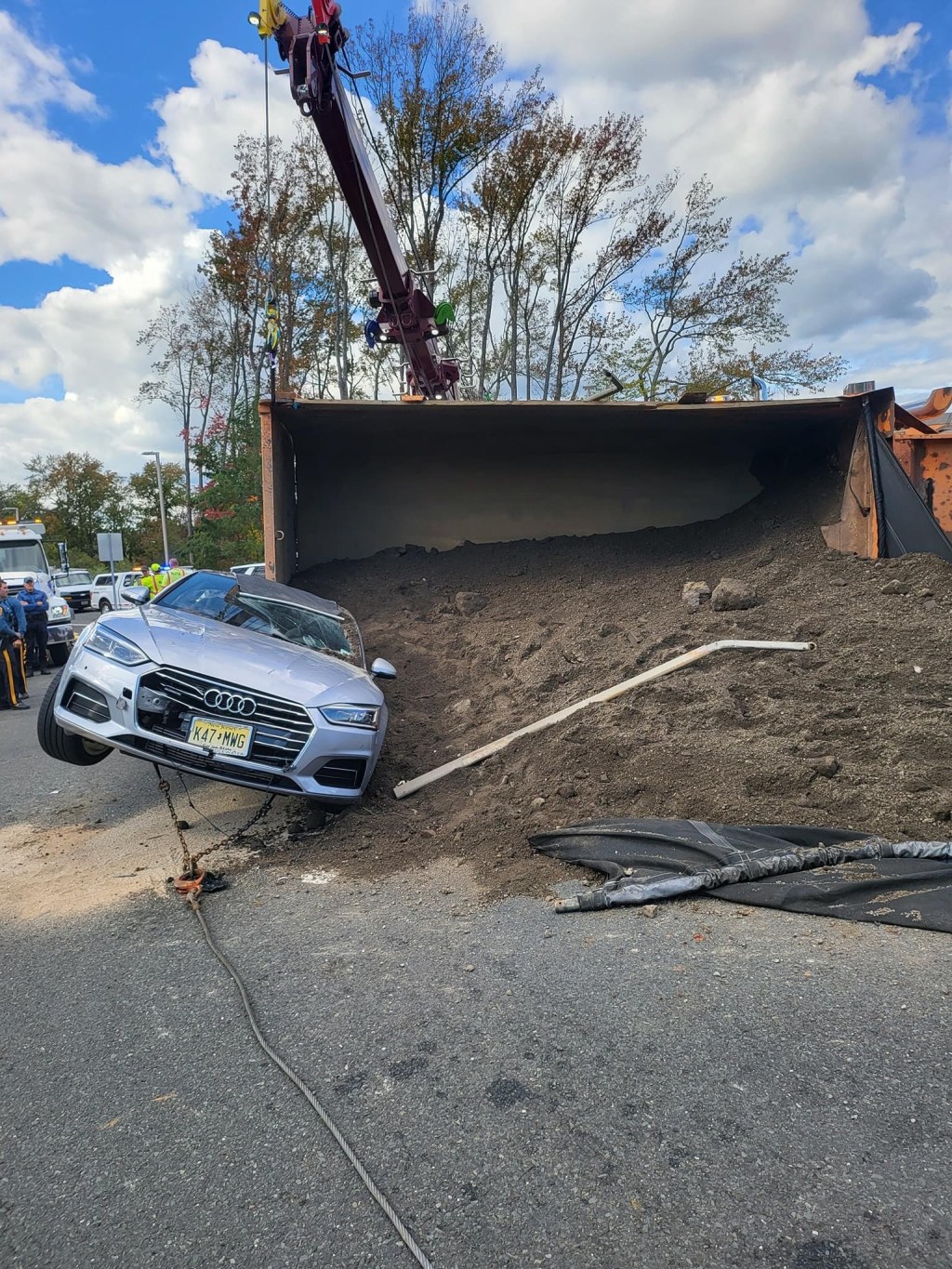Loaded Dump Truck Flips on Top of Car Trapping&nbsp;Infant